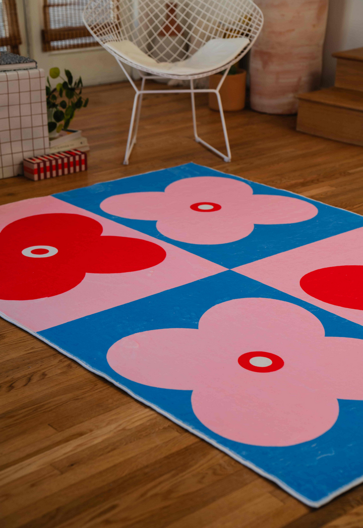 LanySpace Pink and Blue Four Leaf Clover Rug next to chair