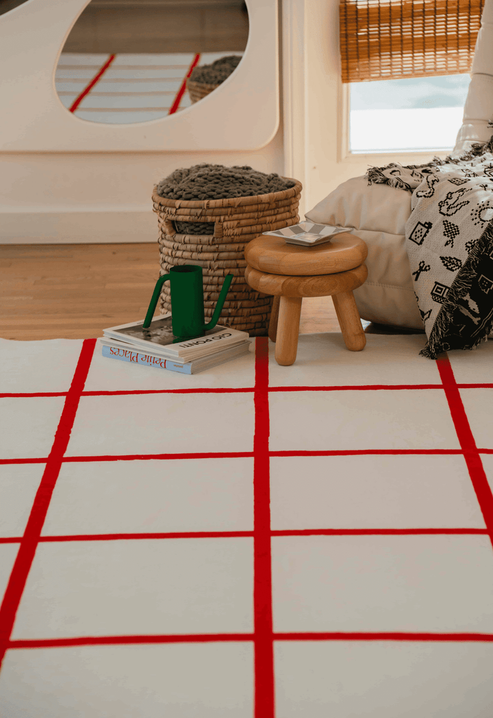 A cozy corner with the LanySpace Red and White Grid Modern Rug