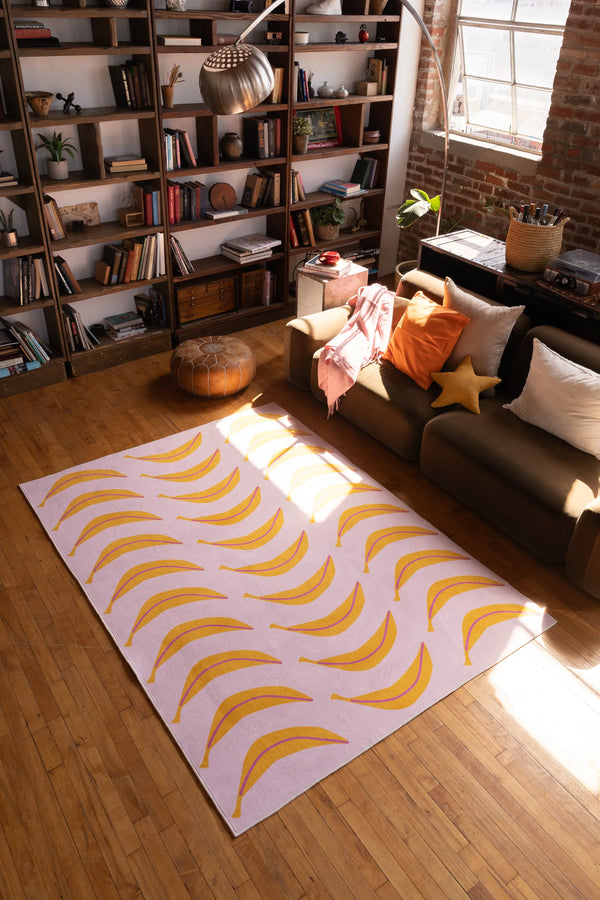 This playful runner adds energy to the sunlit space, positioned centrally between a sofa and bookshelf on wood floor