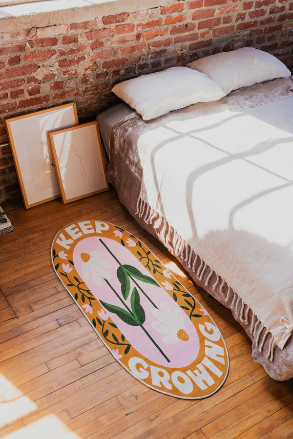 Retro Daisy Quote Rug – “Keep Growing” Oval Rug by Megan Roy