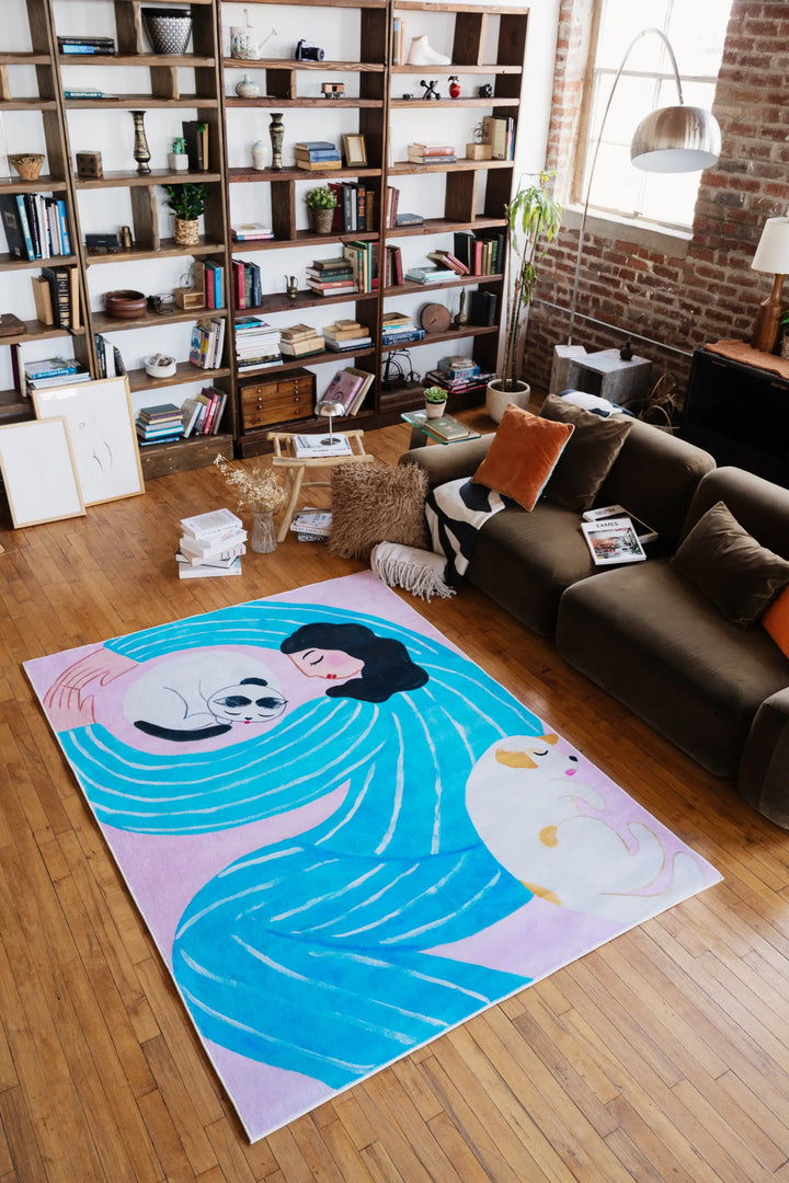 Cat Lover Rug in lilac and blue in 5'X7' feet, placed on a wooden floor beside a cozy sofa with decorative accents.