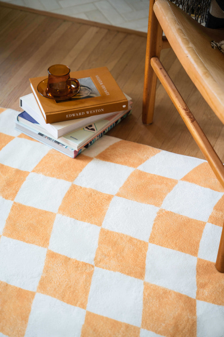 Pile of books on the LanySpace Yellow Wavy Checkered Rug