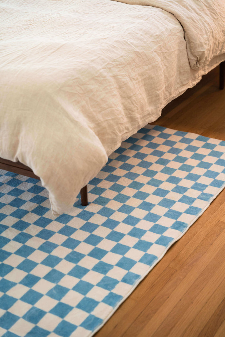 Baby Blue Checkered Area Rug under a bed frame