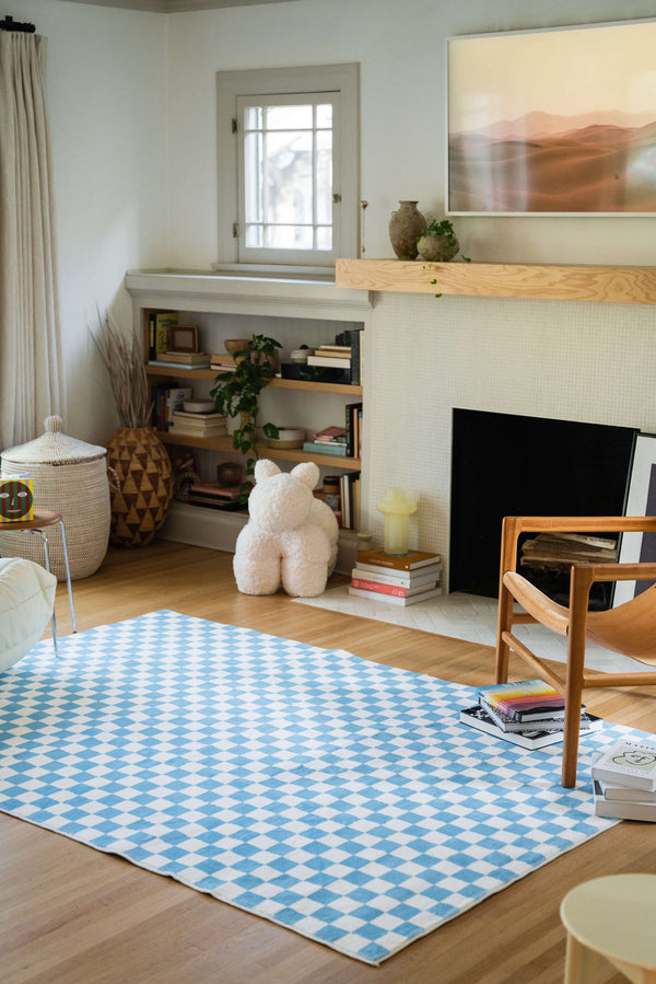 a living room with Baby Blue Checkered Area Rug