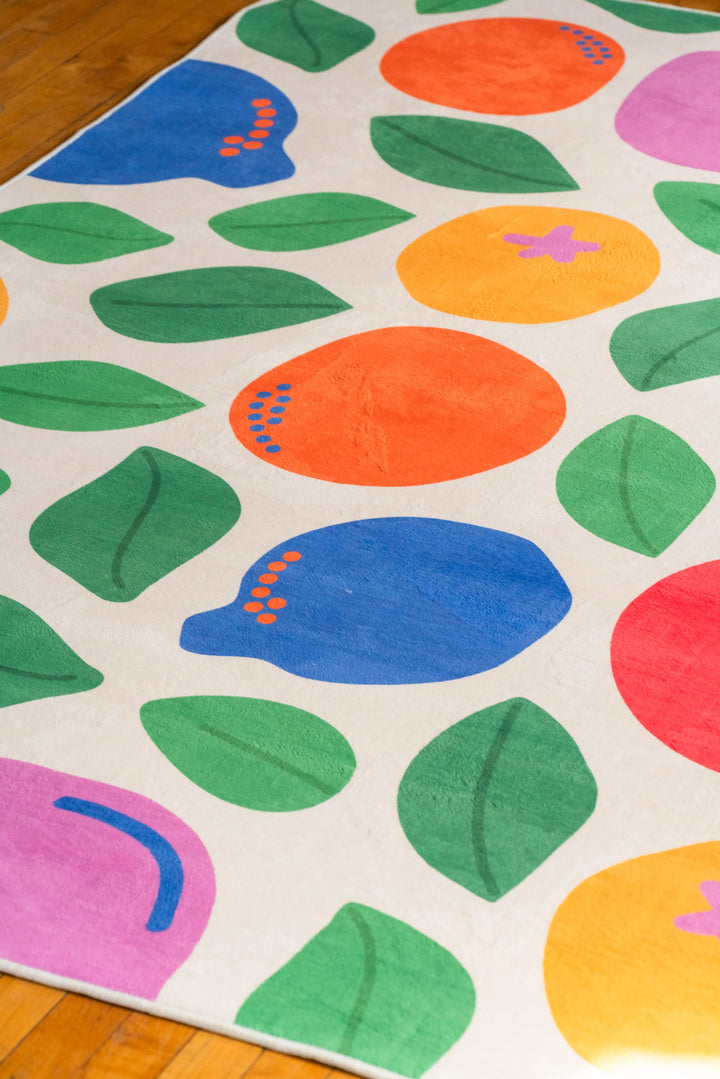 Pastel Fruit Party Rug featuring playful shapes in a bright interior with natural light and wood floor