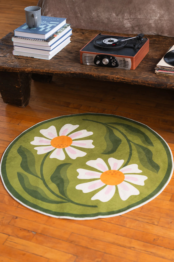 Close-up view of the daisy-patterned rug under a vintage table setup, blending floral freshness with retro vibes.