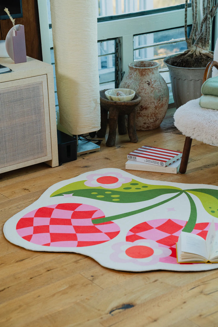 A cozy nook with Jessica Miller Irregular Pink and Red Checkered Cherry Rug, 4' x 4'