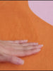 Fingers glide over the Designer Irregular Orange Moss Rug, its soft, plush